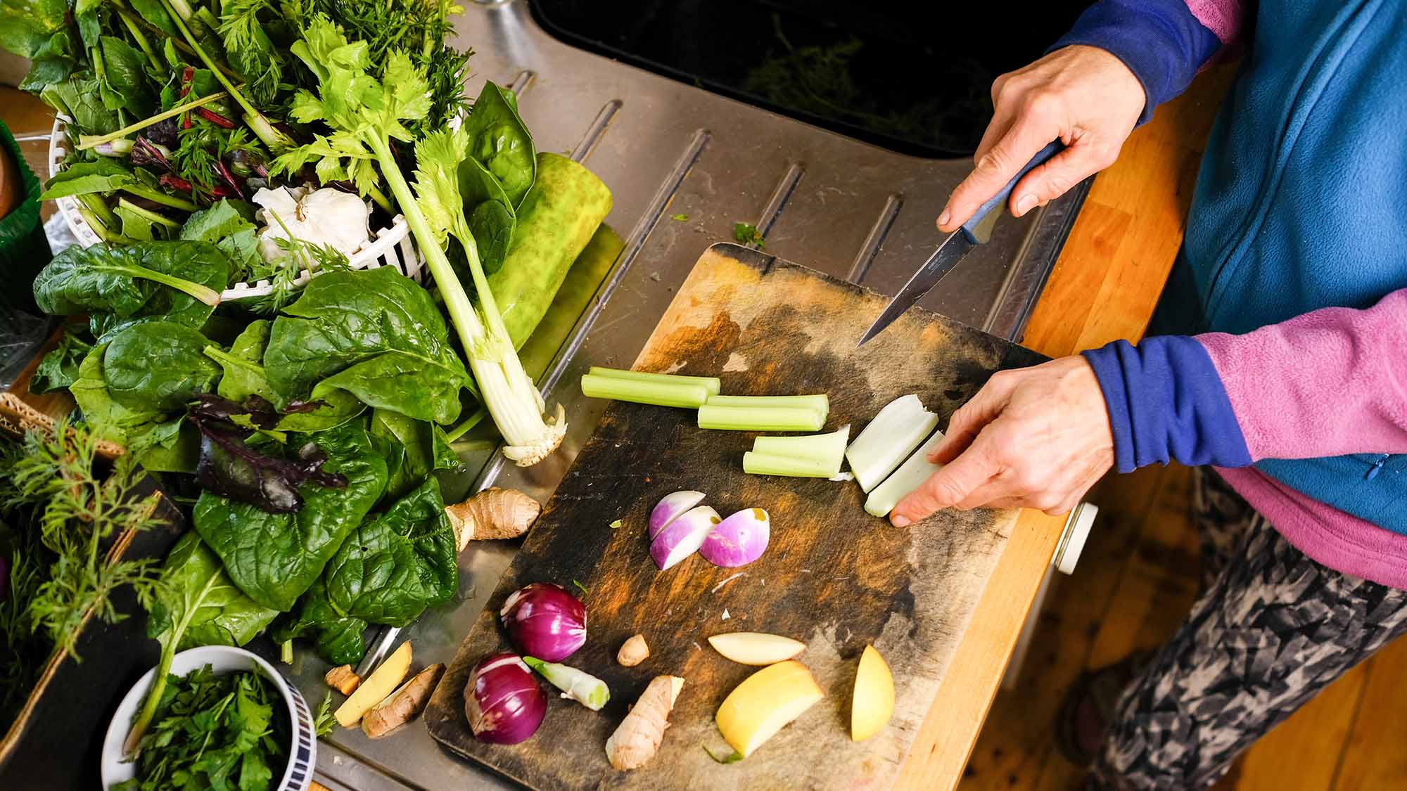 Female hands cutting vegetables on a cutting board